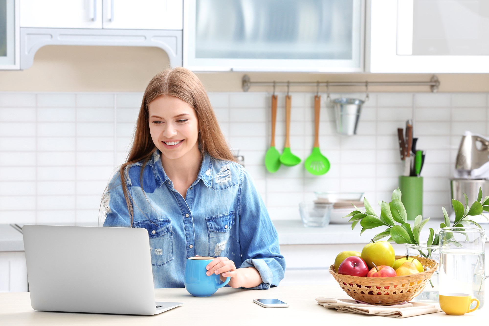 Student smiling while cooking in a home kitchen